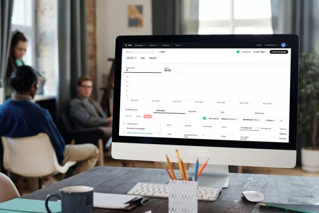 Woman presenting a social media marketing strategy to a team in a modern meeting room.