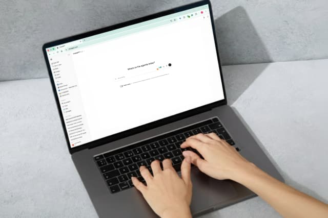 Person typing on a laptop with ChatGPT open on the screen.