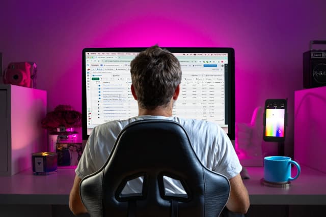 Person working on Meta Ads Manager campaigns on a large desktop screen in a home office.