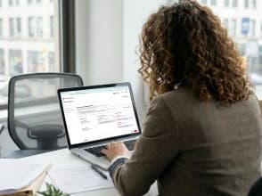 Professional working on a laptop setting up a digital advertising campaign on Pinterest in an office.