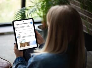 Person viewing a Knowcrunch digital marketing profile on Threads using a tablet.