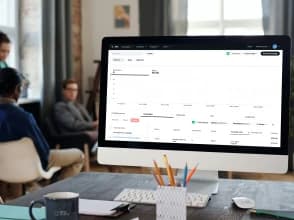 Woman presenting a social media marketing strategy to a team in a modern meeting room.