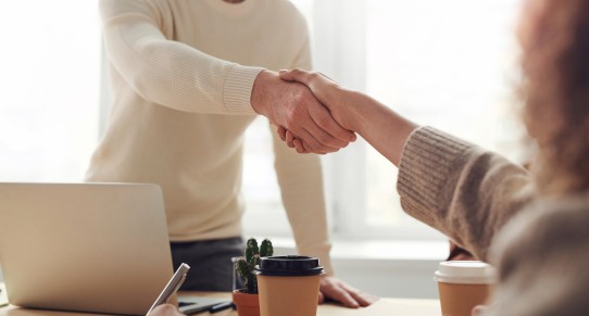 Two people shake hands because they made a business deal with each other.