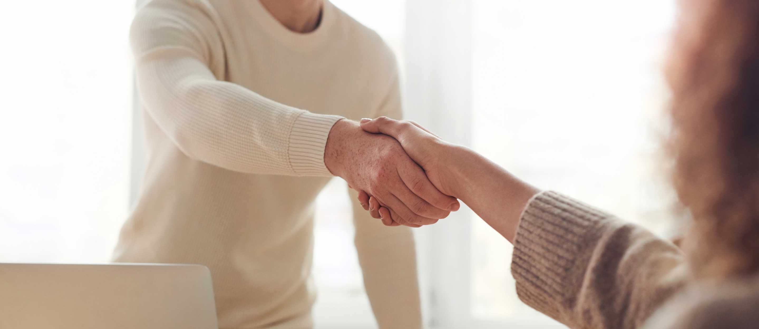 Two people shake hands because they made a business deal with each other.